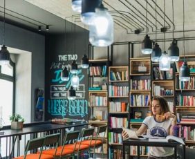 girl-sitting-table-looking-notebook